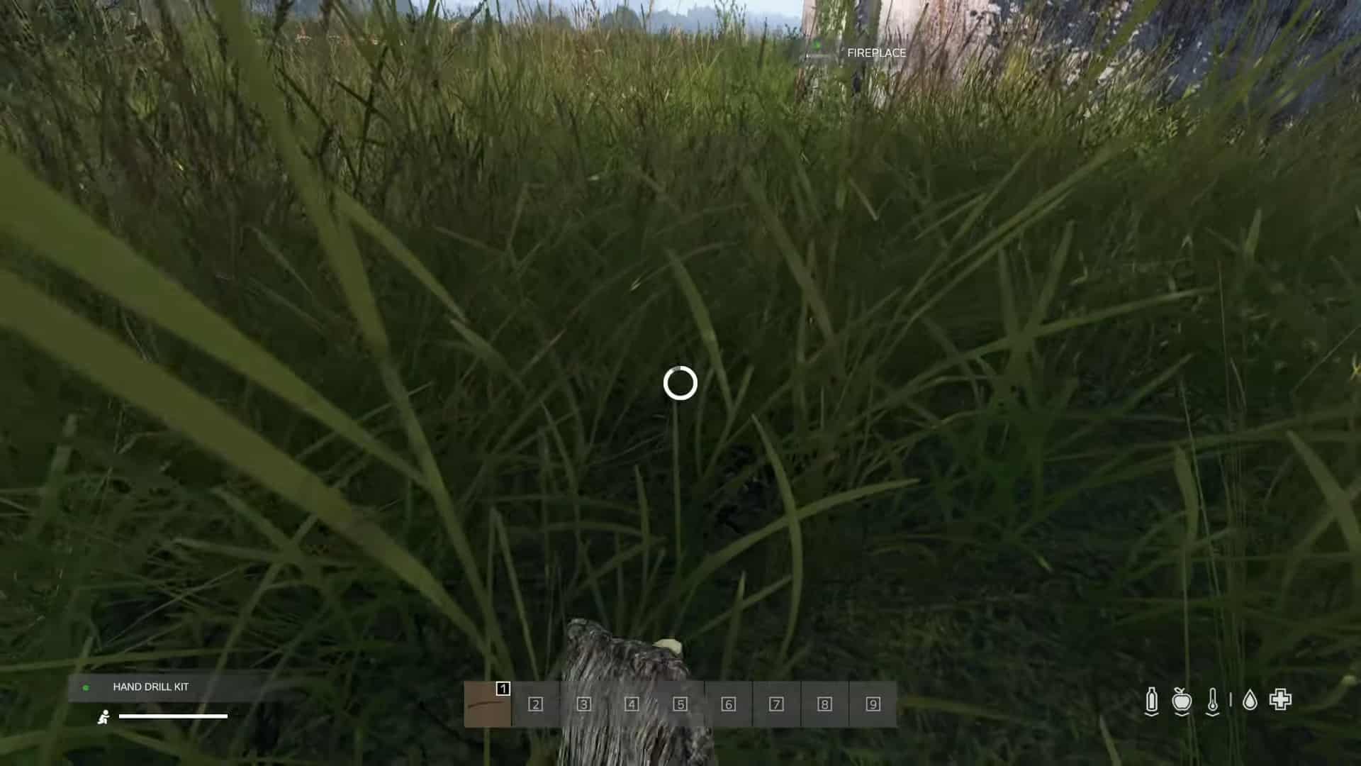 Using a hand drill to ignite a fire in DayZ while laying in grass