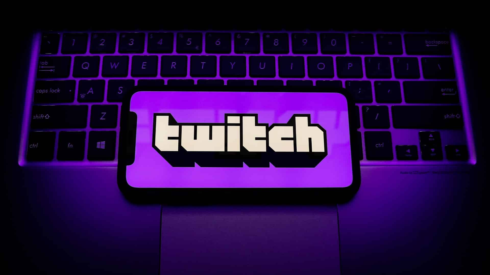 Photo showing a phone with the Twitch logo on the screen.