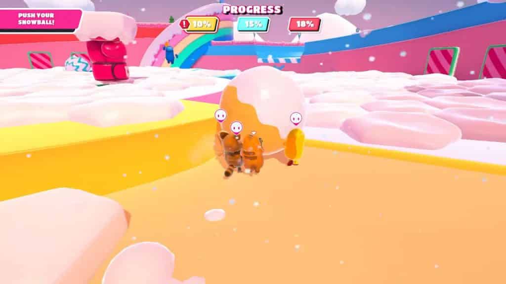yellow team in fall guys pushing snowball