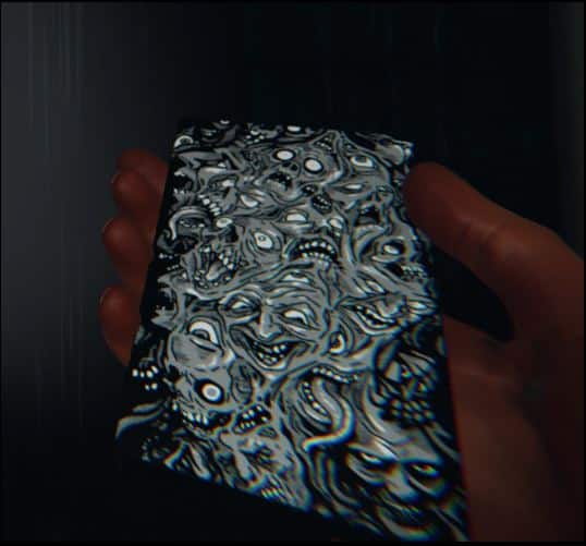 The Tarot deck hosts the image of multiple ghosts and ghouls on a black and silver backed card.