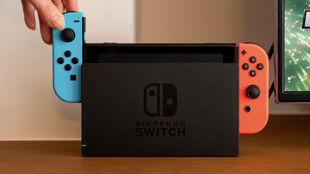 Nintendo Switch being placed into dock of connected to different TV