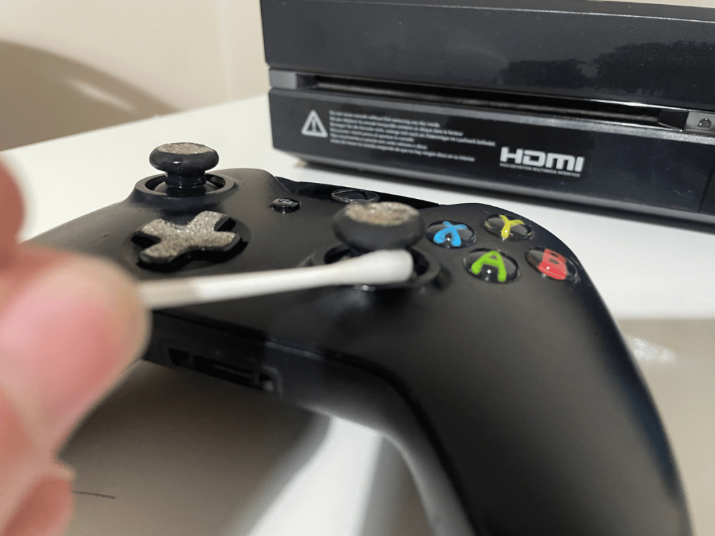 Using cotton bud to get to get into small spots on Xbox One controller