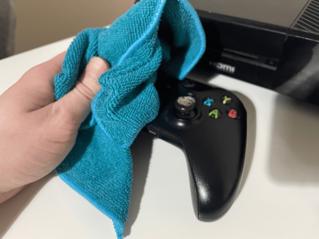 Wiping Xbox One controller with micro fibre cloth